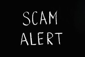 An image that says scam alert.
