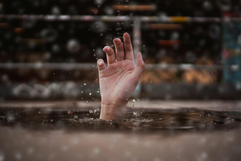 Hand coming out of water.