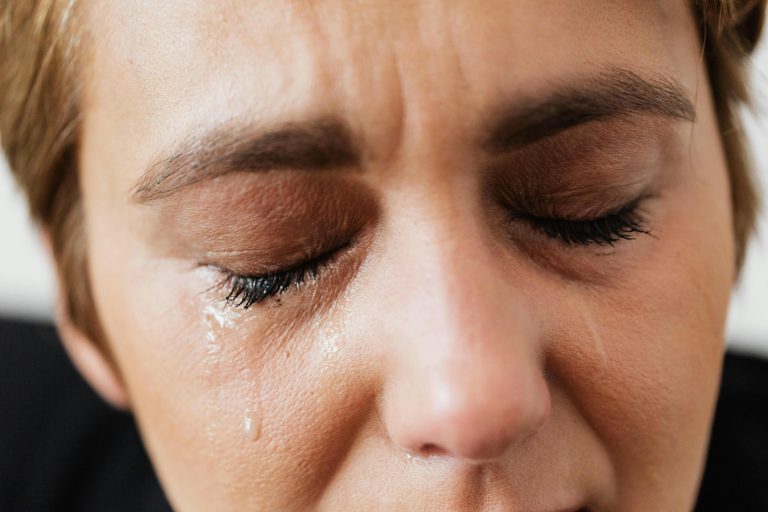 A close-up of a woman crying, symbolizing the emotional toll and regret of buyer’s remorse after moving into a new home.