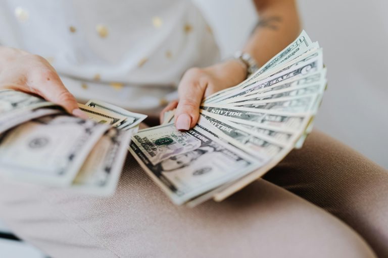 Person counting money, representing questionable or unethical behavior in real estate transactions