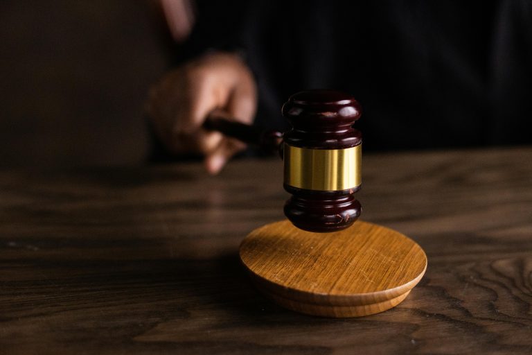 A judge’s gavel hitting a wooden block, symbolizing the realtor settlement and changes to real estate commission rules.