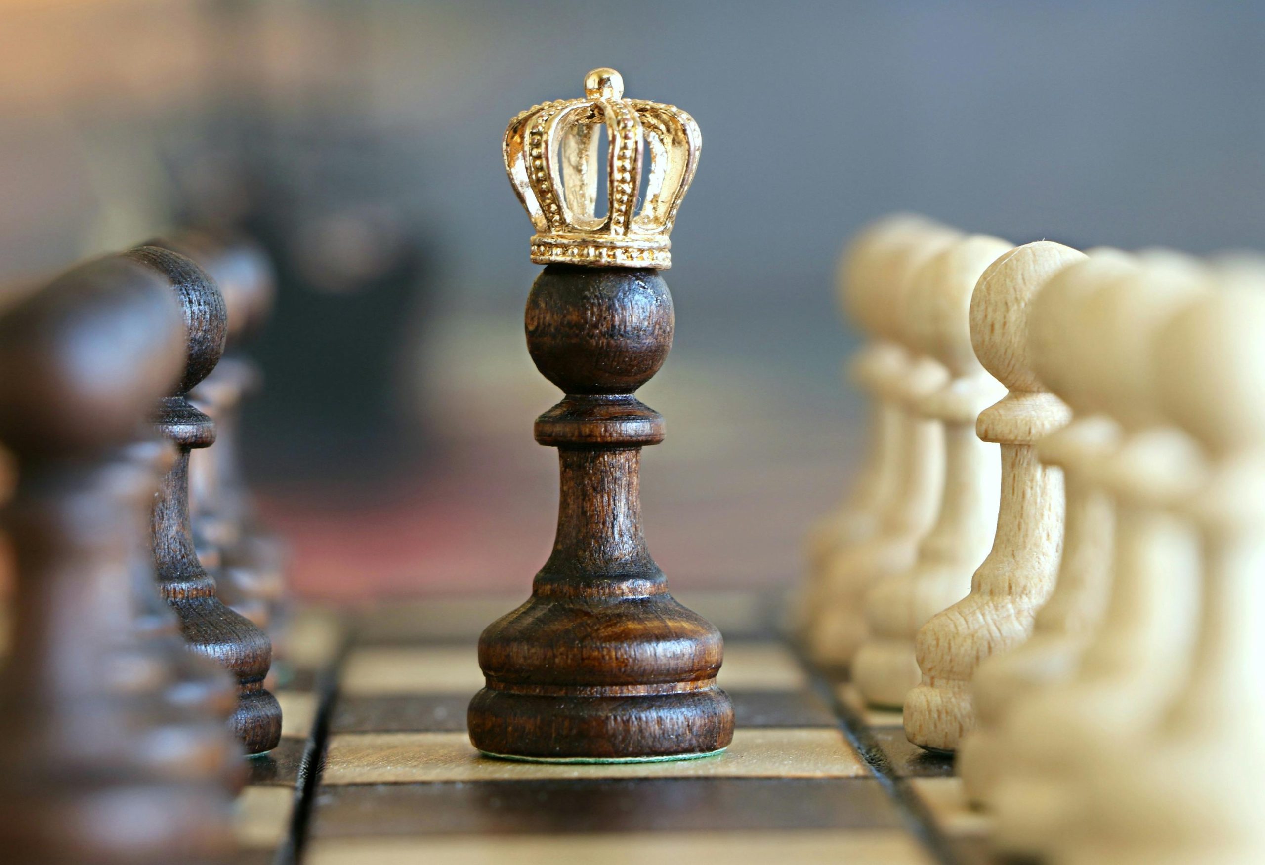 - Unbiased Real Estate Advice: The Truth About Real Estate A chess pawn wearing a crown on a chessboard, symbolizing strategy and smart decision making when buying a home at auction.