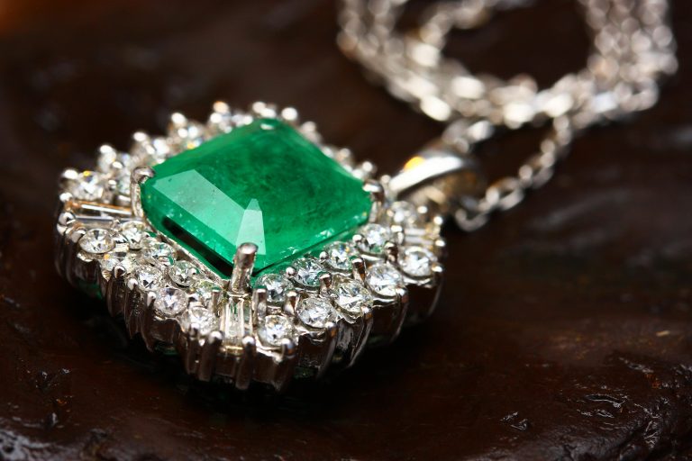 Close up of a diamond and emerald necklace representing valuables at risk of theft during home showings.