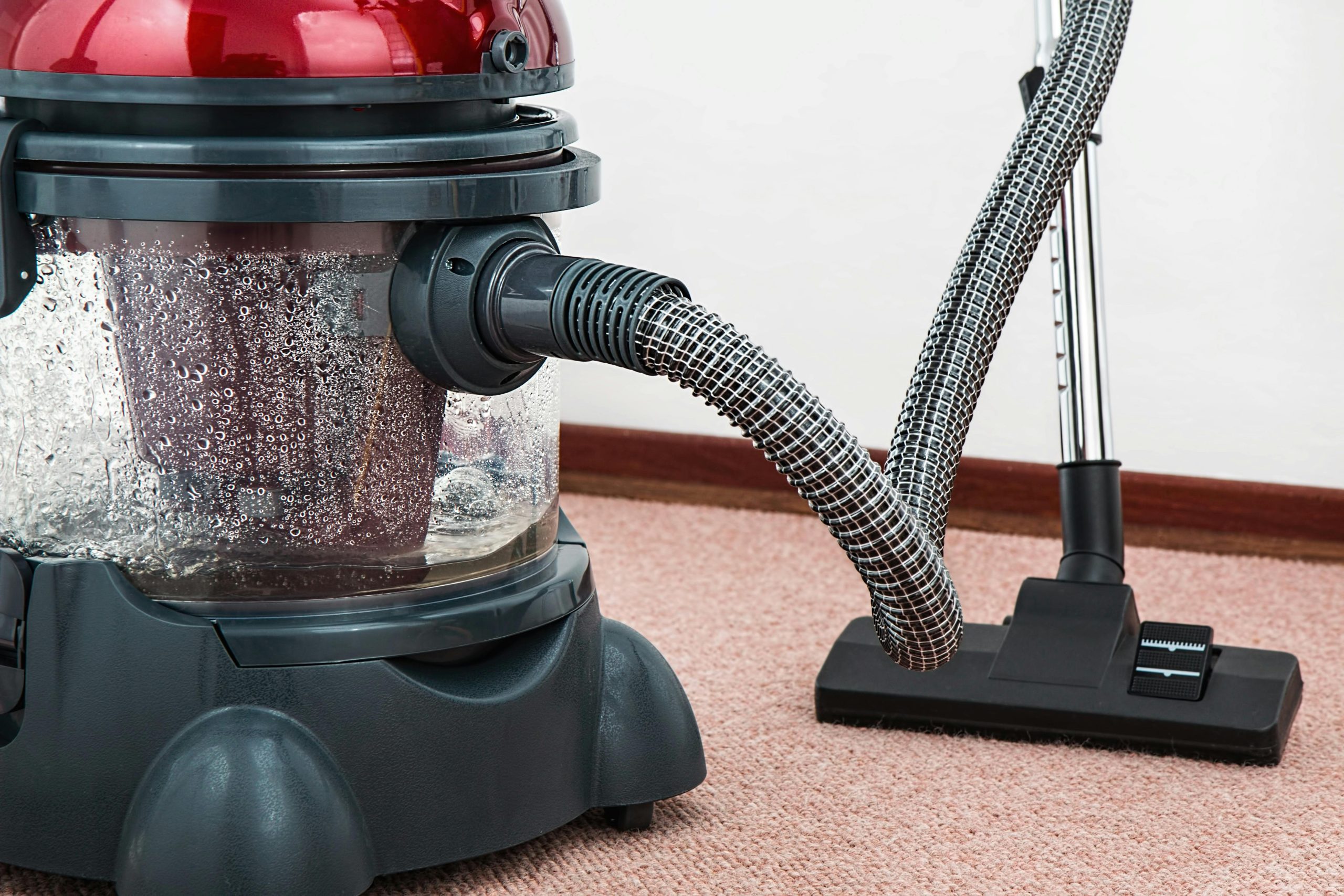 - Unbiased Real Estate Advice: The Truth About Real Estate Close-up of a vacuum cleaner on carpet, representing the importance of new carpet and clean flooring when preparing a home for sale.