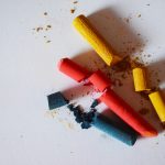 Broken colored chalk pieces on a white surface, symbolizing a real estate deal that failed to close.